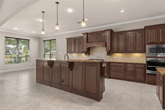 a kitchen with granite countertop cabinets and window