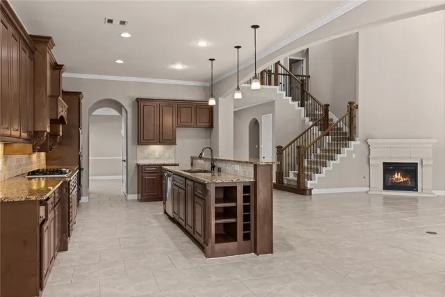 a kitchen with granite countertop a sink and cabinets