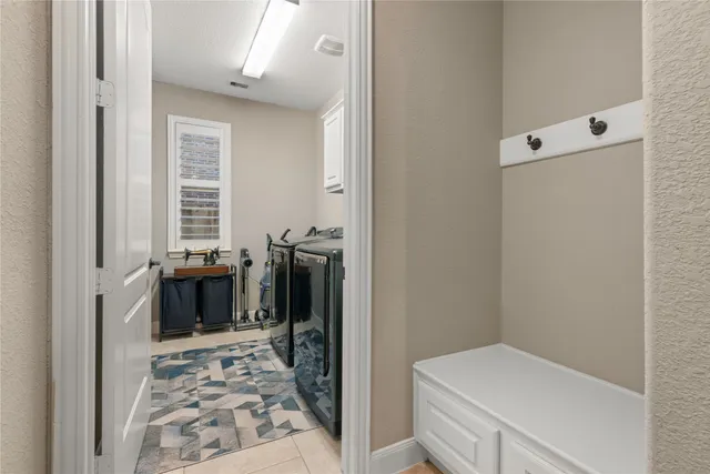 a view of a patio with couches and table and chairs with wooden fence and large trees