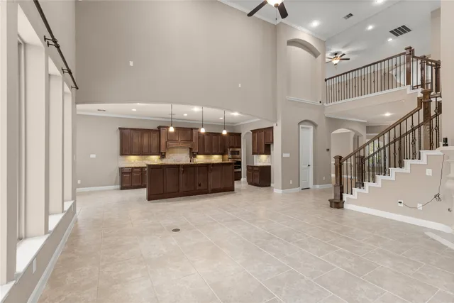 a kitchen with granite countertop a sink a counter top space appliances and cabinets