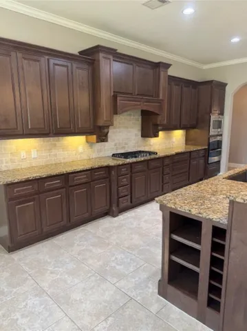 a view of a kitchen with large windows