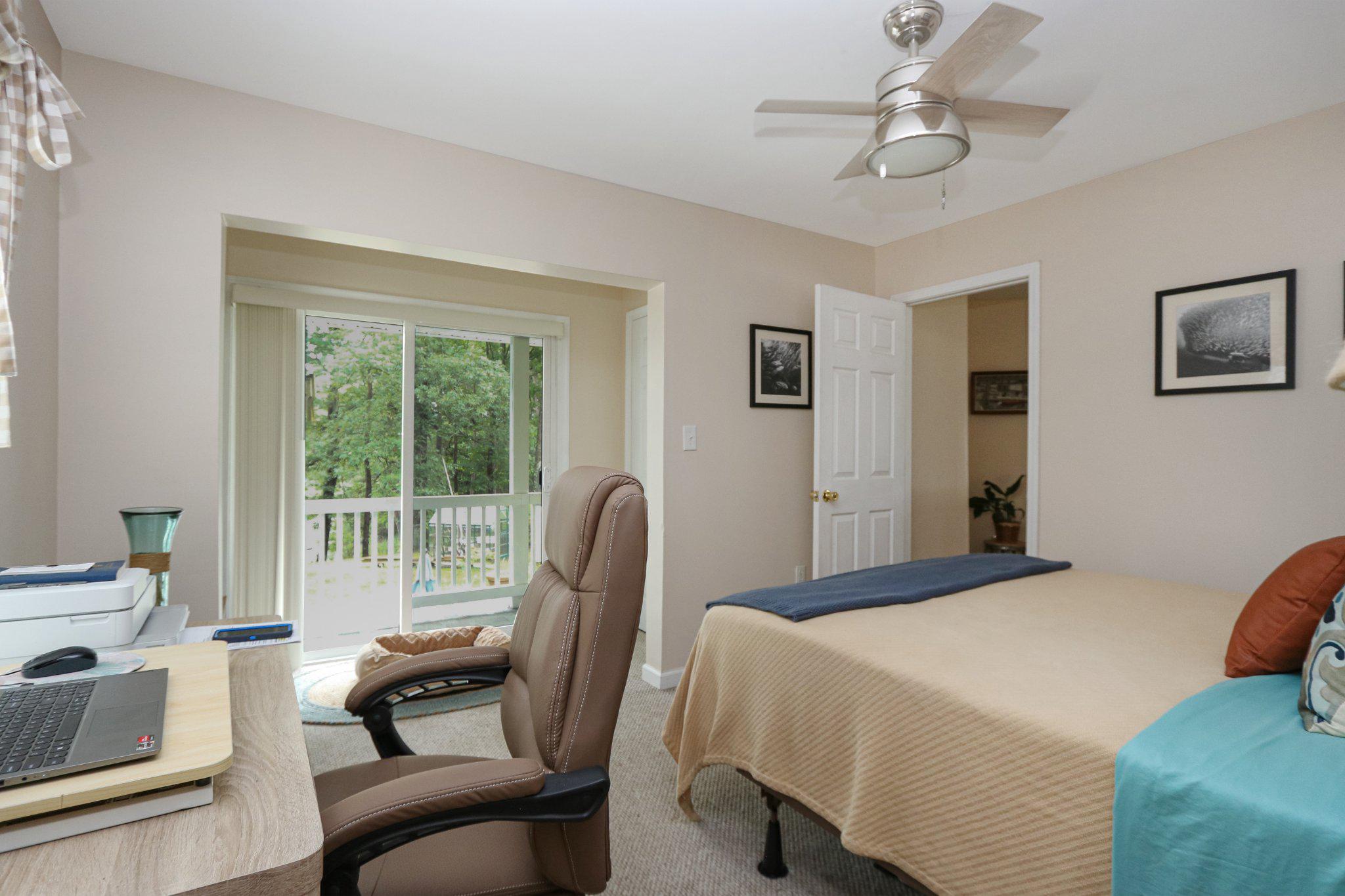 13431 Solitude Trail Machipongo, VA 23405 - Photo 24 of 32 Serene bedroom with nature views.