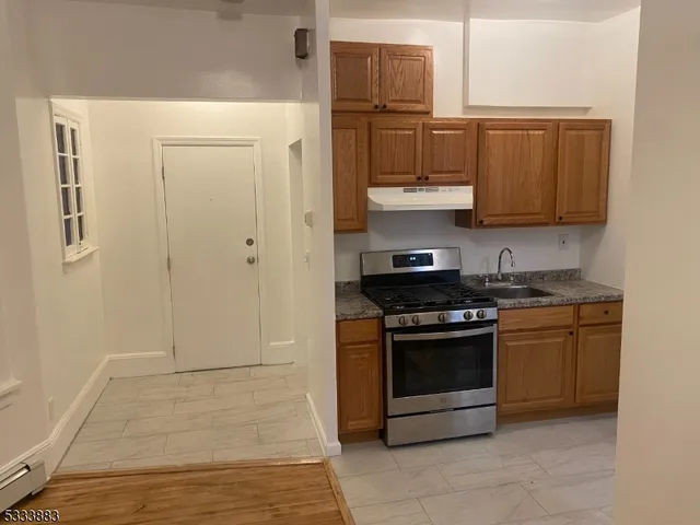 a kitchen with stainless steel appliances granite countertop a stove and a refrigerator