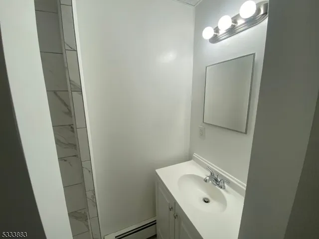 a bathroom with a sink and mirror