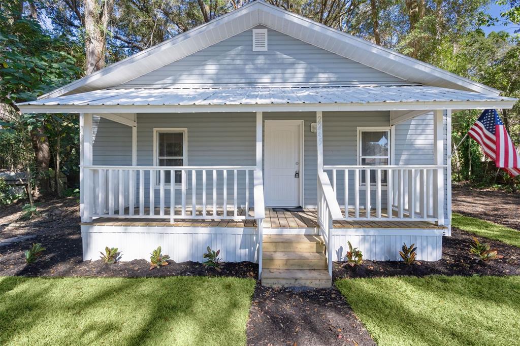 a front view of a house with yard and deck