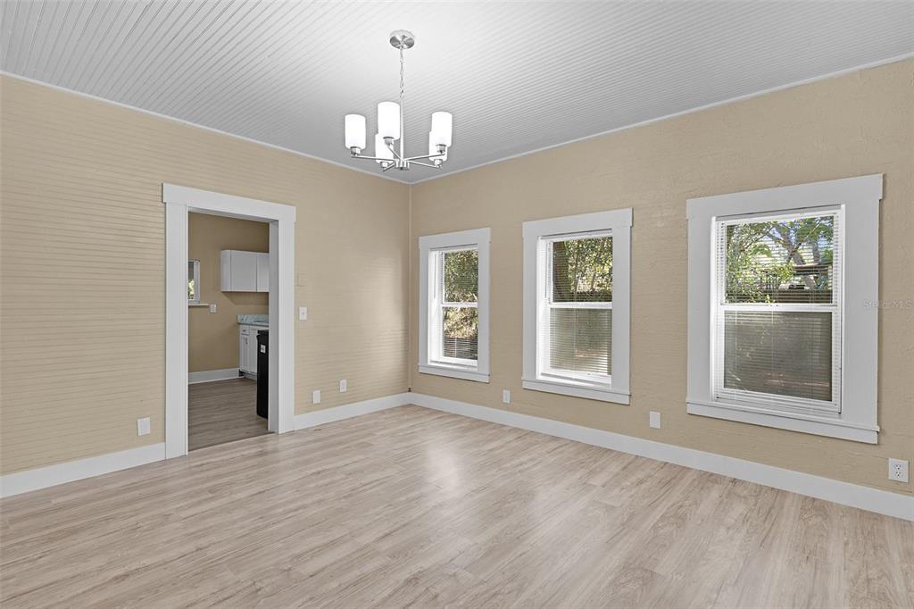 2245 Northwest 63rd Place Ocala, FL 34475 - Photo 11 of 38 a view of an empty room with wooden floor and a window