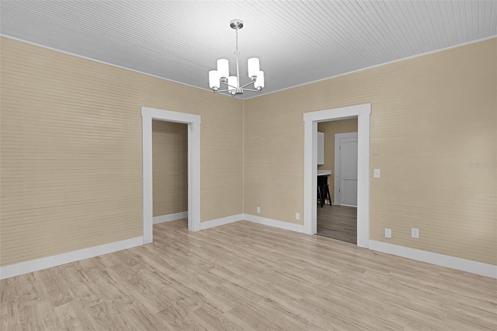 2245 Northwest 63rd Place Ocala, FL 34475 - Photo 12 of 38 wooden floor in an empty room with a window