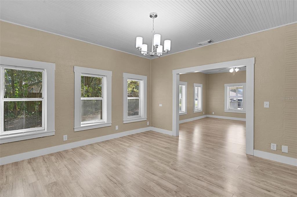 2245 Northwest 63rd Place Ocala, FL 34475 - Photo 13 of 38 a view of an empty room with wooden floor and a window