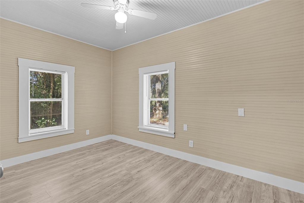 2245 Northwest 63rd Place Ocala, FL 34475 - Photo 20 of 38 a view of an empty room with wooden floor and a window