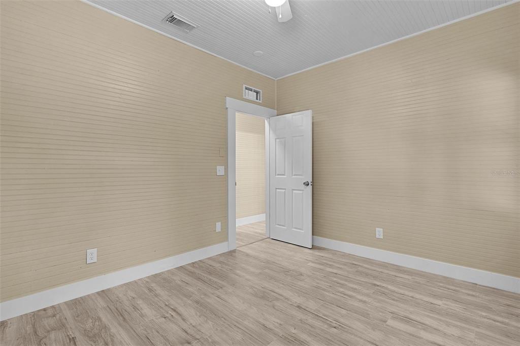 2245 Northwest 63rd Place Ocala, FL 34475 - Photo 22 of 38 a view of an empty room with wooden floor