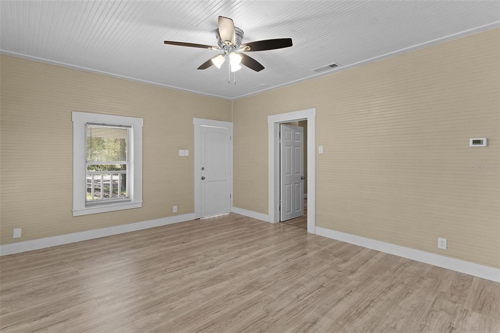 2245 Northwest 63rd Place Ocala, FL 34475 - Photo 29 of 38 wooden floor in an empty room with a window