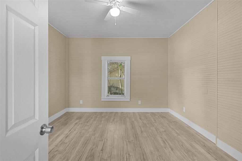 2245 Northwest 63rd Place Ocala, FL 34475 - Photo 30 of 38 wooden floor in an empty room with a window