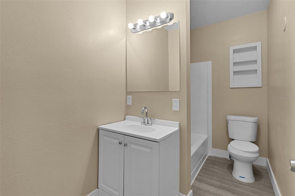 2245 Northwest 63rd Place Ocala, FL 34475 - Photo 32 of 38 a white toilet sitting next to a bathroom sink