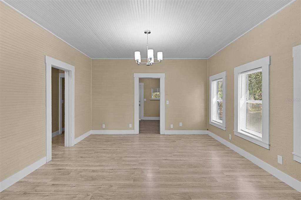 2245 Northwest 63rd Place Ocala, FL 34475 - Photo 9 of 38 a view of an empty room with wooden floor and a window