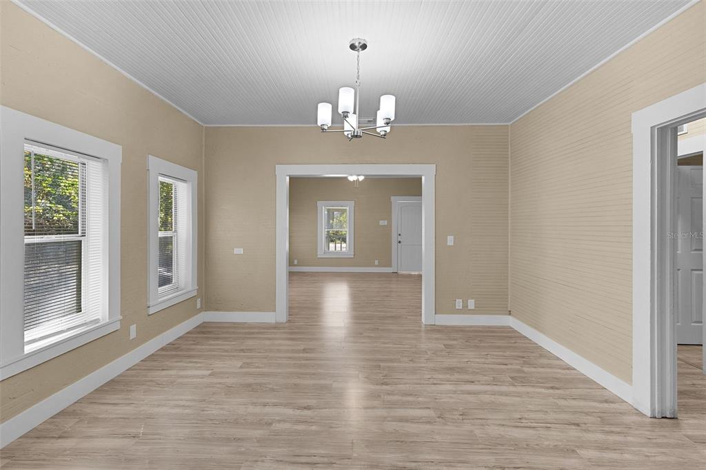 2245 Northwest 63rd Place Ocala, FL 34475 - Photo 10 of 38 wooden floor in an empty room with a window