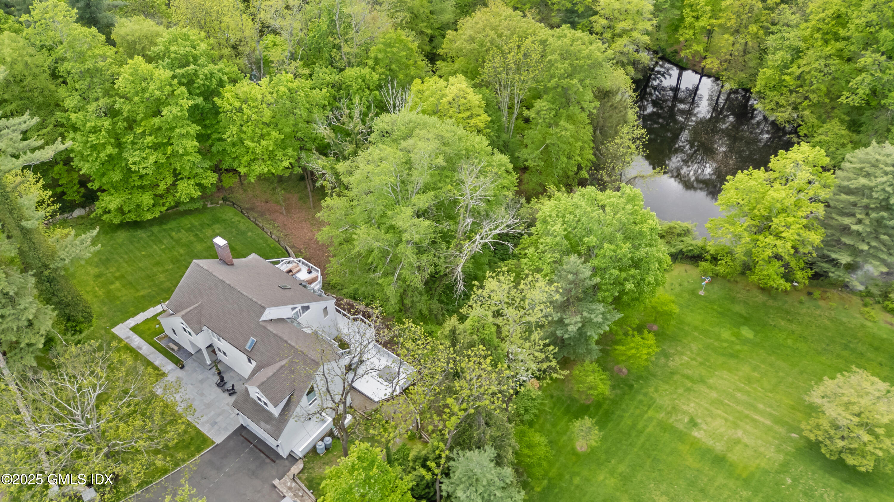 254 Stanwich Road Greenwich, CT 06830 - Photo 1 of 52 an aerial view of a house with a yard