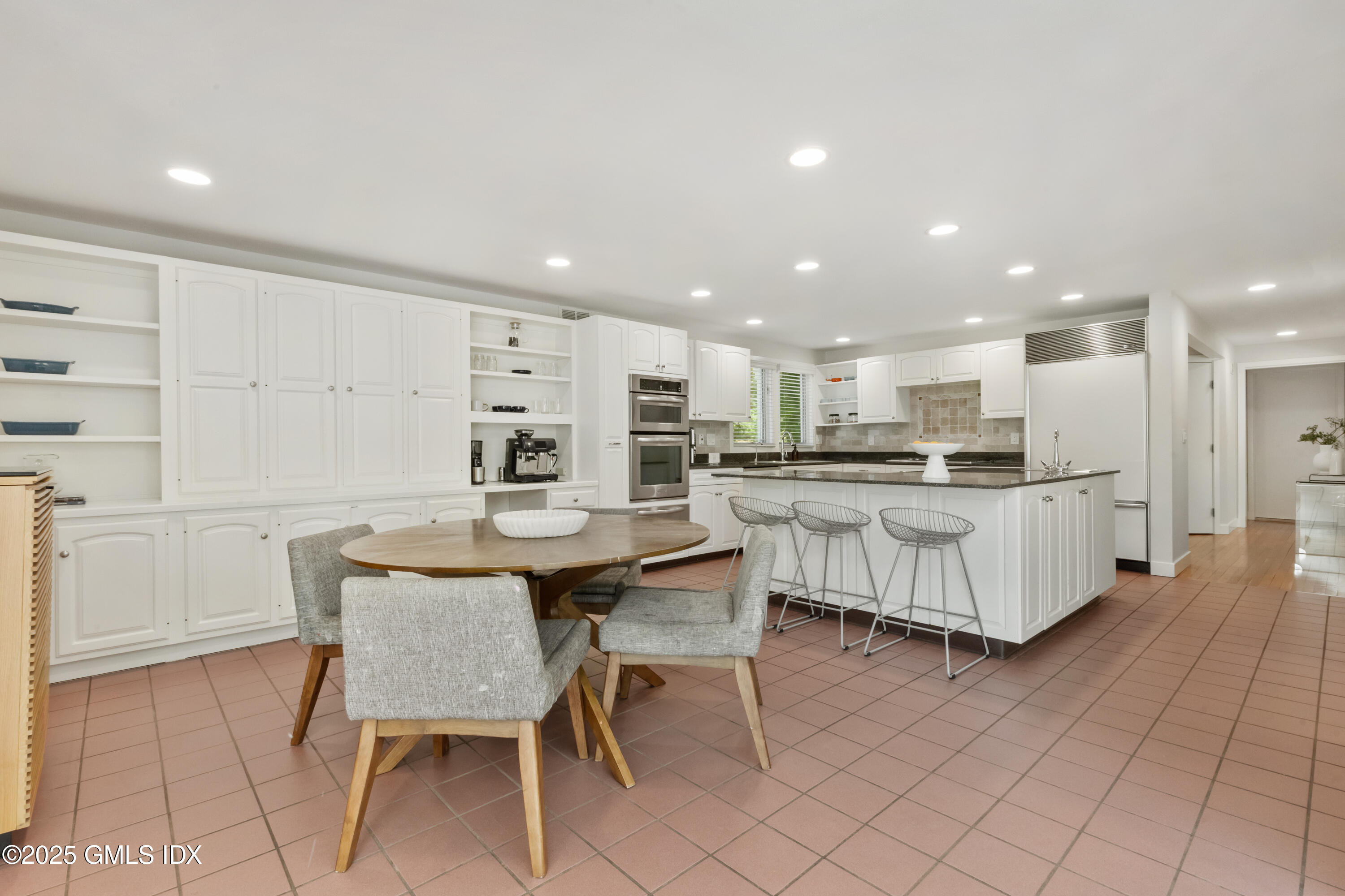 254 Stanwich Road Greenwich, CT 06830 - Photo 14 of 52 a kitchen with a table chairs a sink dishwasher and cabinets with wooden floor