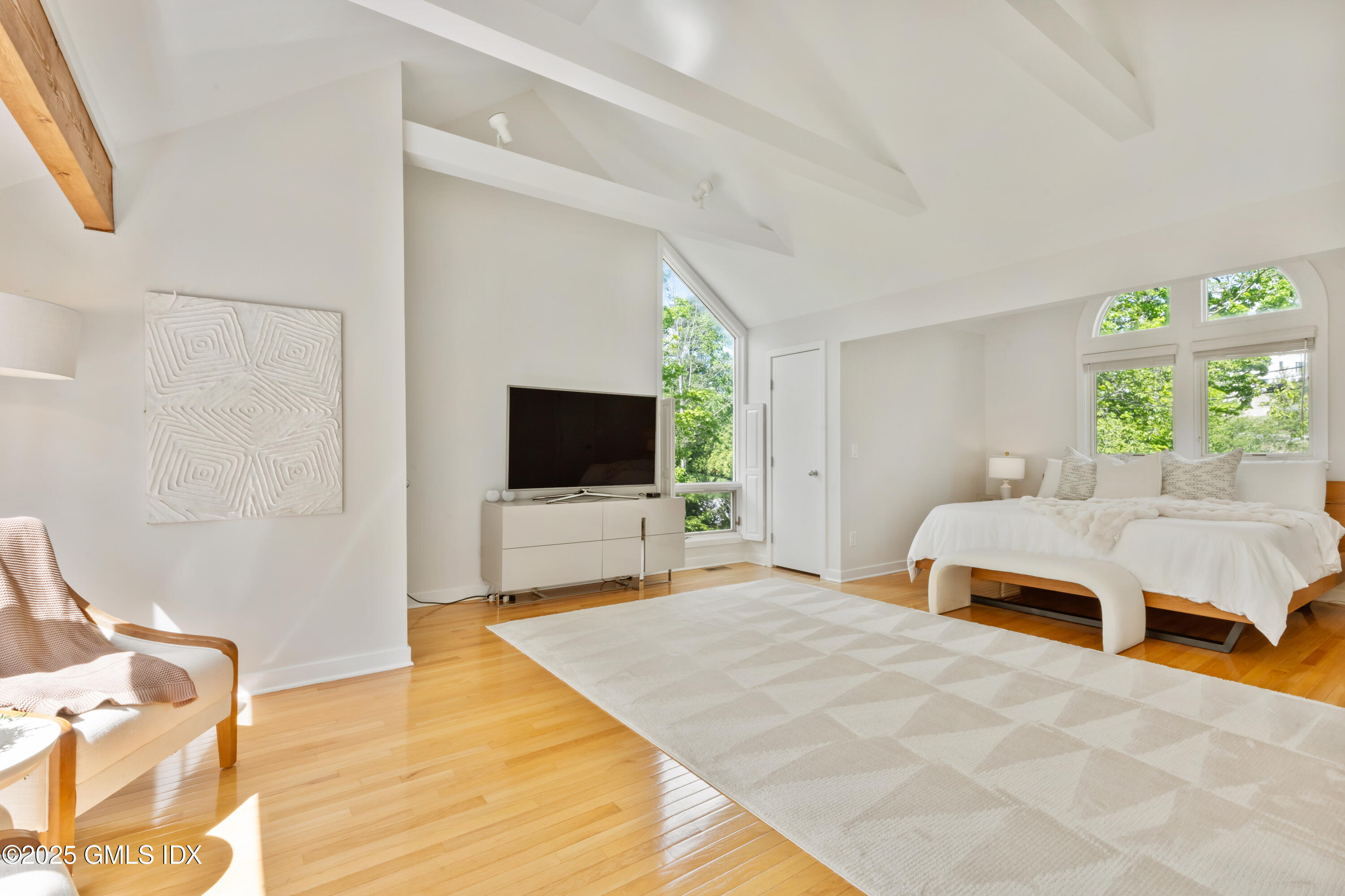 254 Stanwich Road Greenwich, CT 06830 - Photo 20 of 52 a bedroom with a bed and a flat screen tv