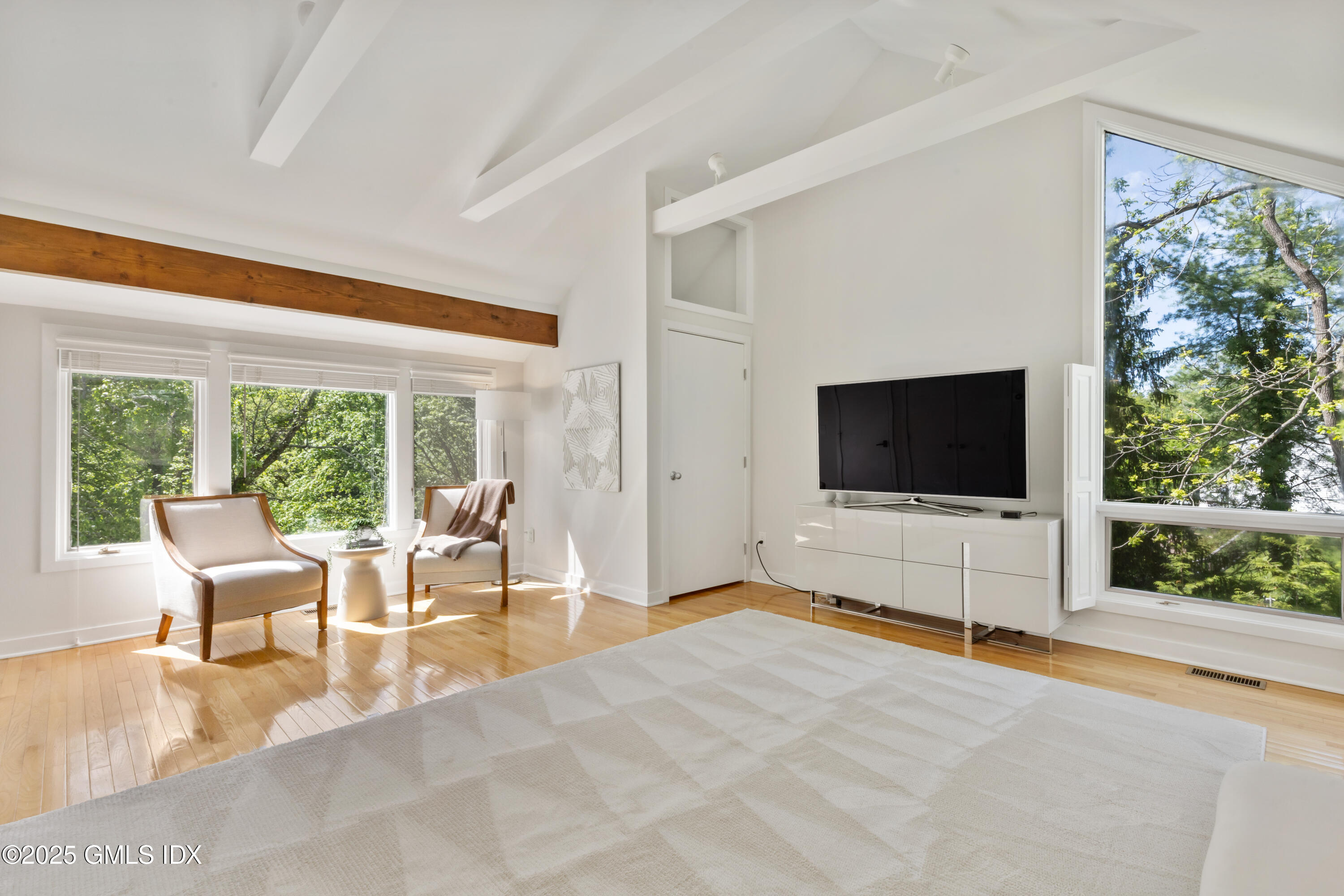 254 Stanwich Road Greenwich, CT 06830 - Photo 21 of 52 a living room with furniture a flat screen tv and a floor to ceiling window