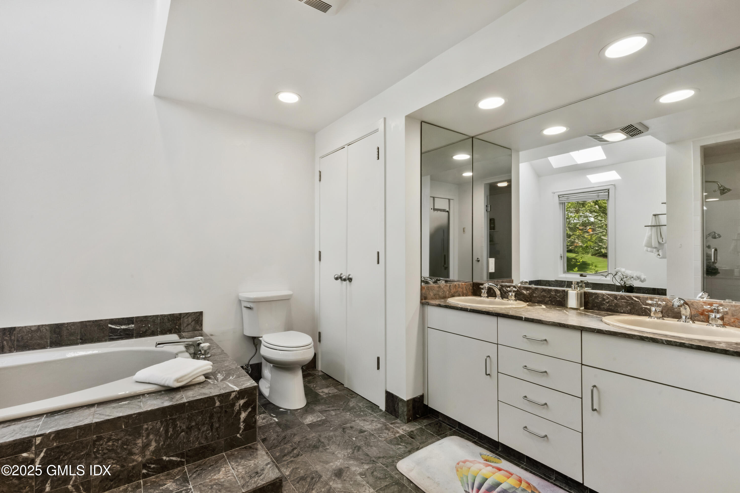 254 Stanwich Road Greenwich, CT 06830 - Photo 23 of 52 a bathroom with a double vanity sink toilet and mirror