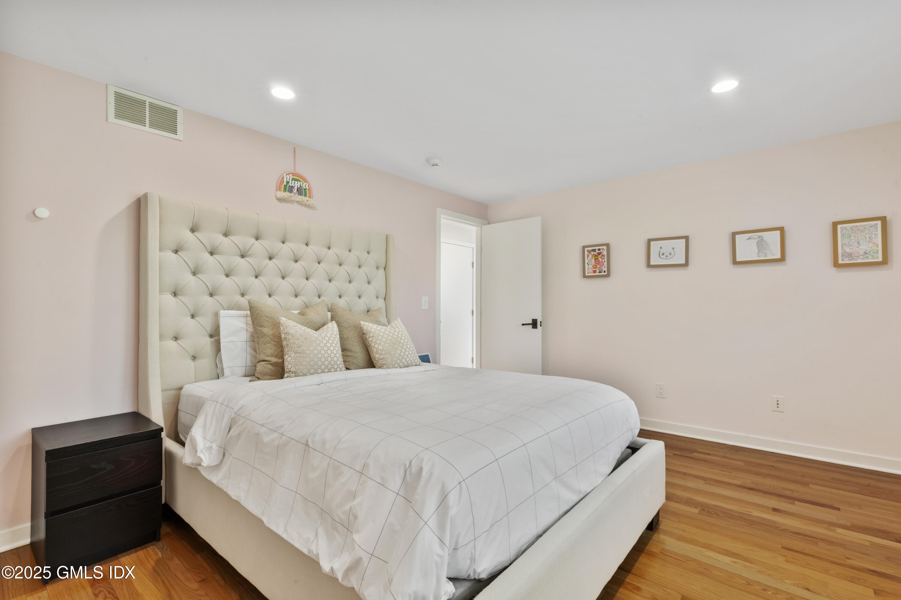254 Stanwich Road Greenwich, CT 06830 - Photo 24 of 52 a bedroom with a bed and wooden floor