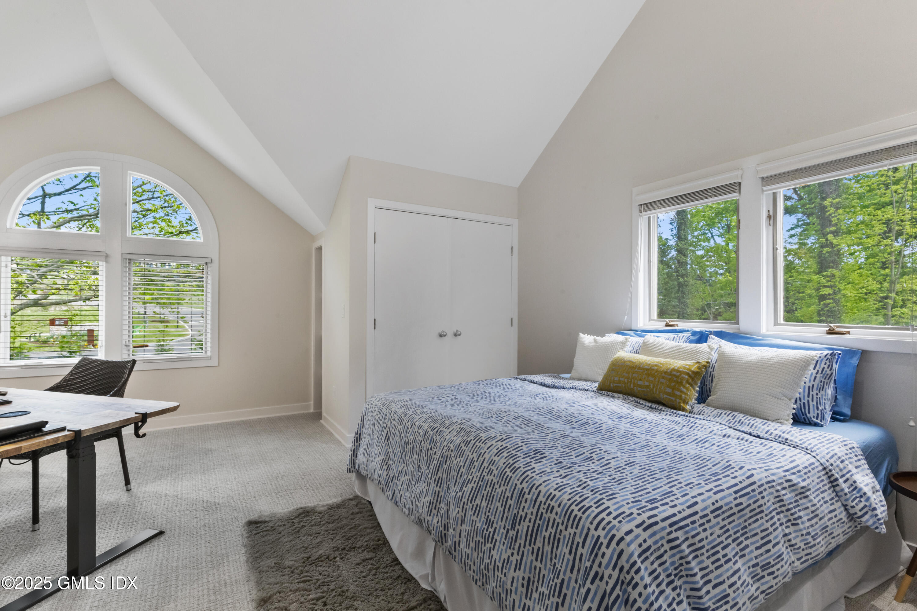 254 Stanwich Road Greenwich, CT 06830 - Photo 25 of 52 a bedroom with a large bed and a large window