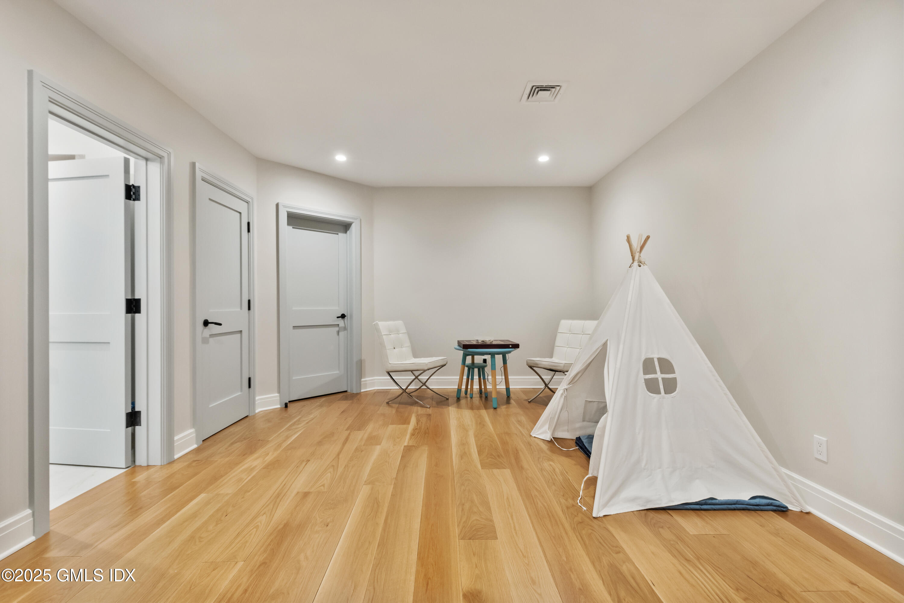 254 Stanwich Road Greenwich, CT 06830 - Photo 38 of 52 a view of a bedroom with wooden floor and staircase