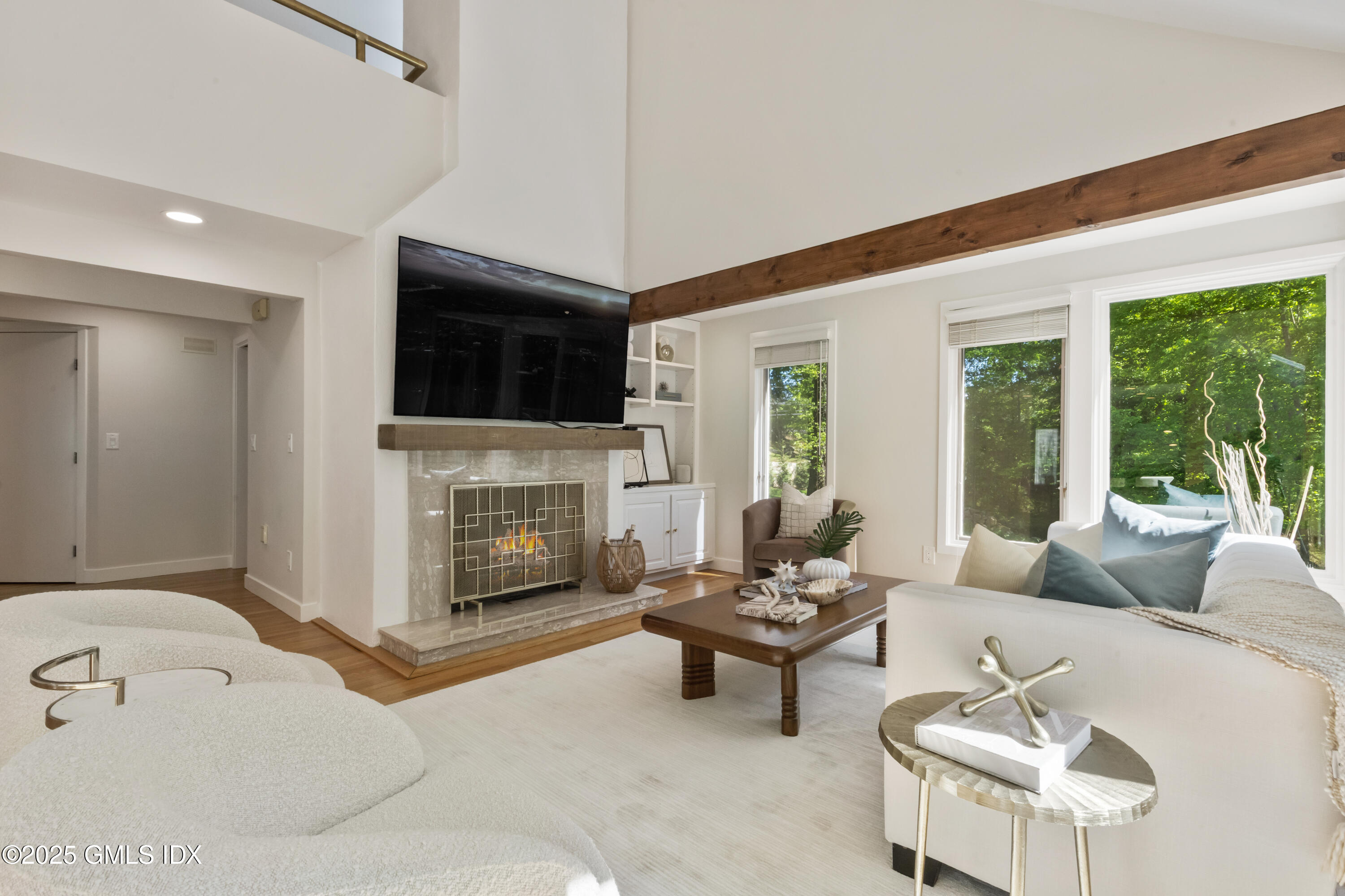 254 Stanwich Road Greenwich, CT 06830 - Photo 4 of 52 a living room with furniture a fireplace and a flat screen tv