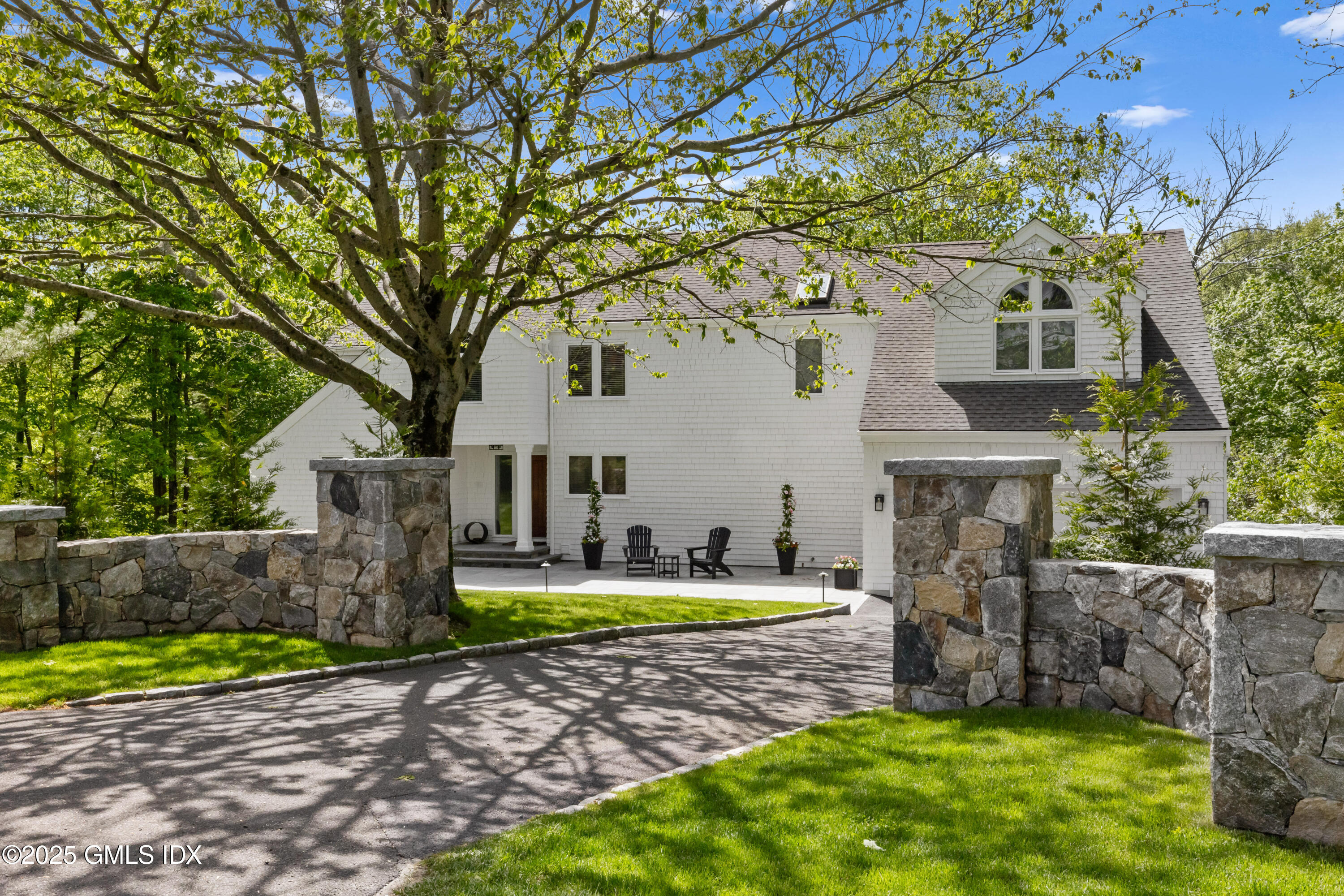254 Stanwich Road Greenwich, CT 06830 - Photo 44 of 52 a front view of a house with a yard