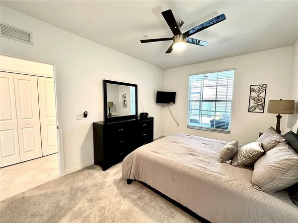 a bedroom with a bed and a chandelier