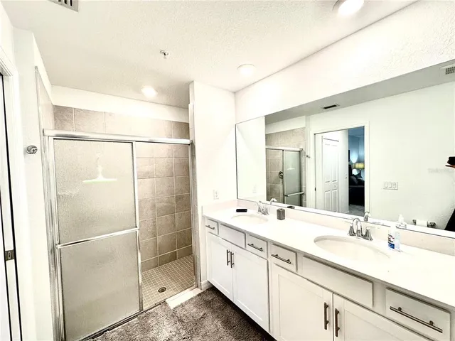 a bedroom with a large bed and a tv