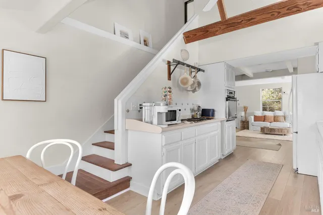 a view of a bedroom with wooden floor and windows