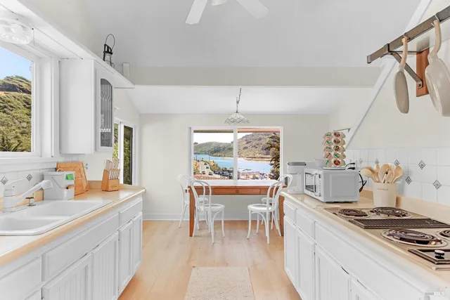 a view of a hallway with wooden floor and windows