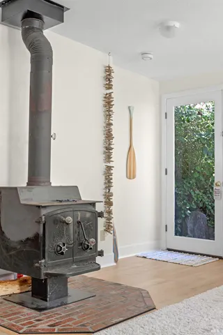 a bathroom with a granite countertop sink a toilet a mirror and shower
