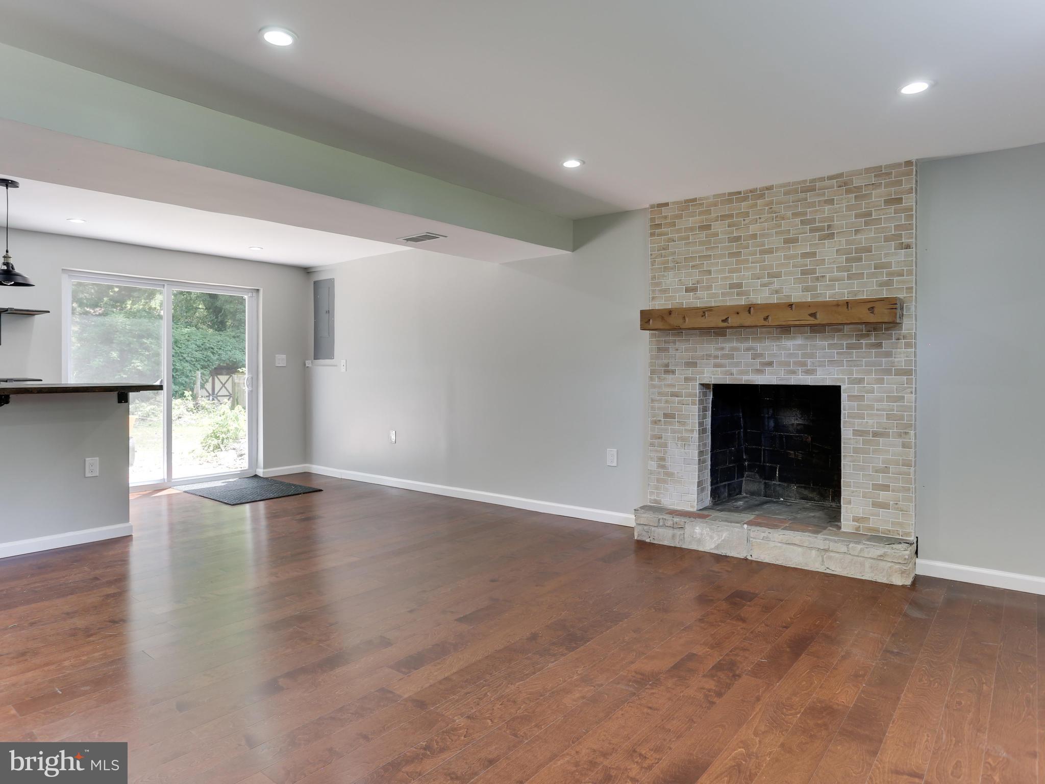 11218 Brandywine Road Clinton, MD 20735 - Photo 18 of 28 Wet bar plus fireplace with bright natural light