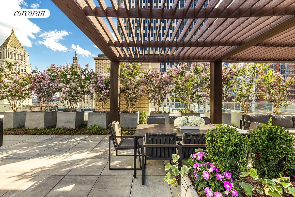 108 Leonard Street, Unit 4N Manhattan, NY 10013 - Photo 14 of 18 a view of a patio with table and chairs and potted plants