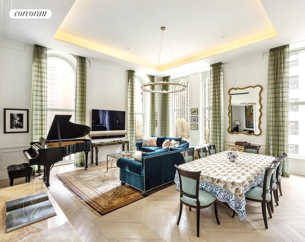 a living room with furniture a flat screen tv and a large window