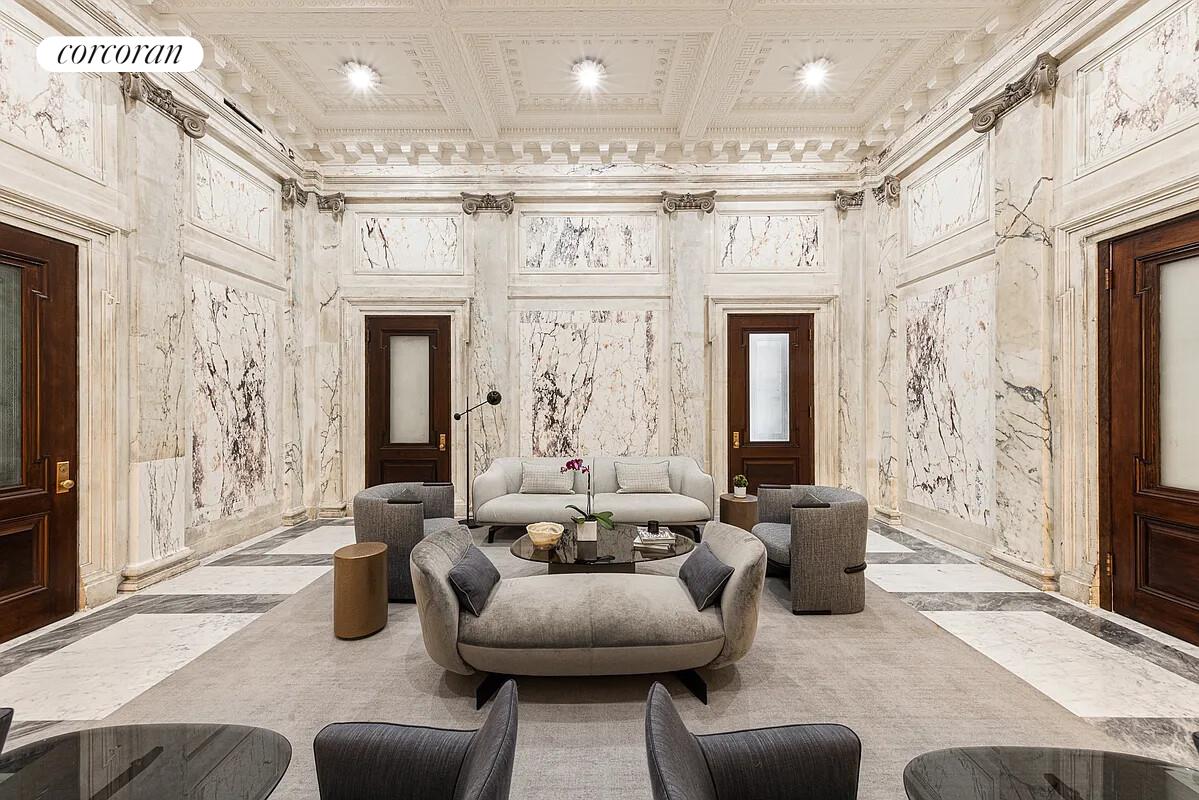 108 Leonard Street, Unit 4N Manhattan, NY 10013 - Photo 20 of 31 a living room with furniture a fireplace and a chandelier