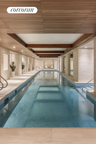 a living room with furniture a fireplace and a chandelier