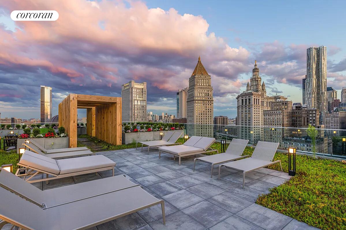 108 Leonard Street, Unit 4N Manhattan, NY 10013 - Photo 27 of 31 a view of a patio with couches and a table and chairs with wooden fence