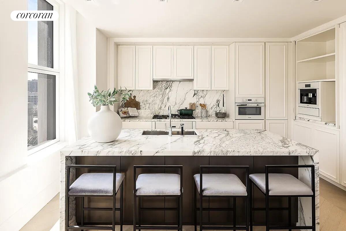 108 Leonard Street, Unit 4N Manhattan, NY 10013 - Photo 2 of 31 a kitchen with granite countertop a table chairs sink and cabinets