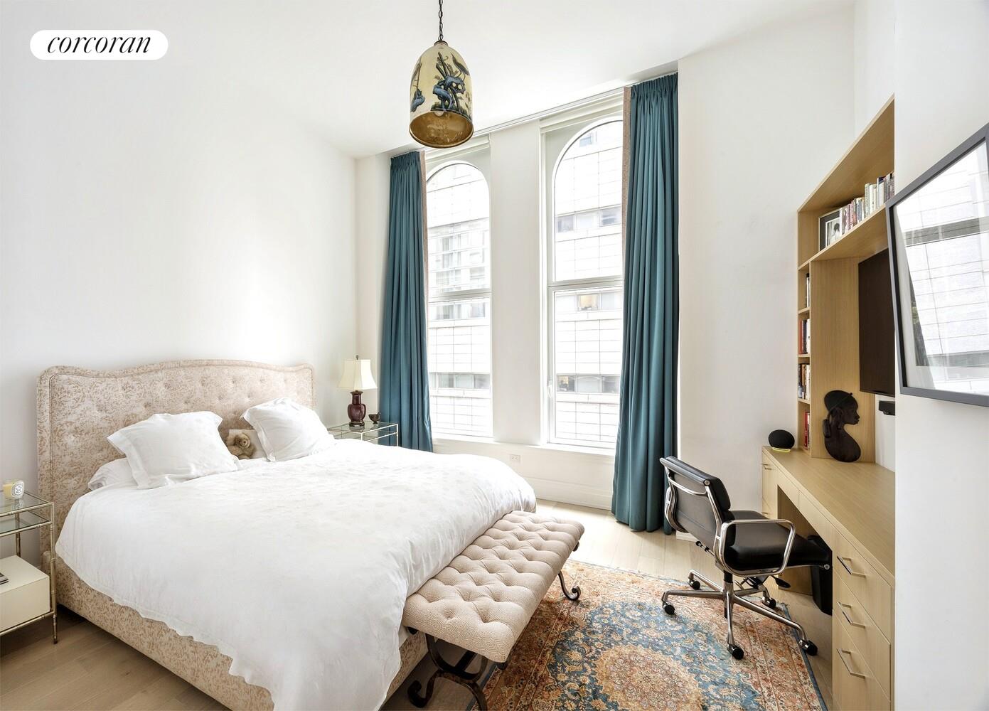 108 Leonard Street, Unit 4N Manhattan, NY 10013 - Photo 6 of 31 a bedroom with a bed and a table in it with window