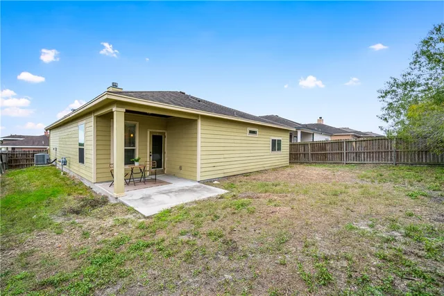 a front view of house with backyard and green space