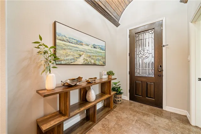 a view of a workspace with furniture and window