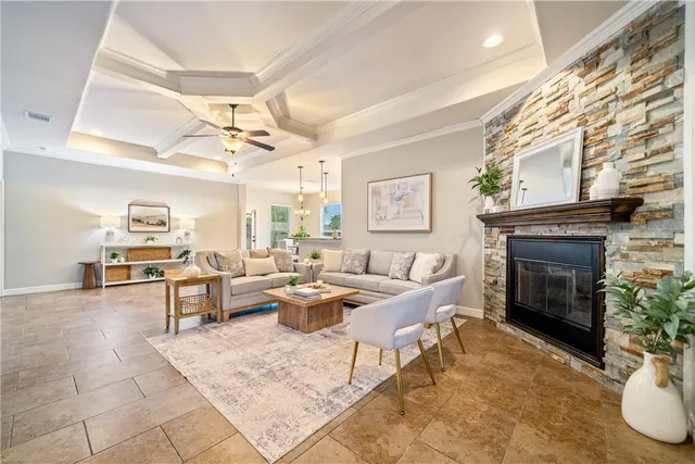 a living room with furniture a fireplace and a chandelier