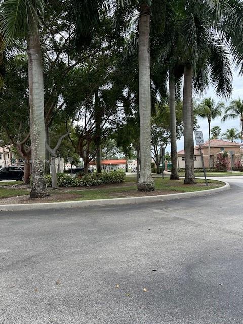 2920 Southeast 13th Road, Unit 20345 Homestead, FL 33035 - Photo 2 of 17 a view of road with trees