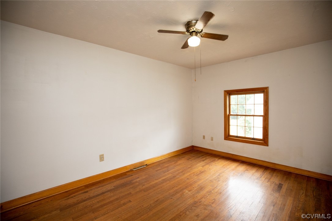 71 Spillman Road Farmville, VA 23901 - Photo 23 of 48 an empty room with wooden floor and windows