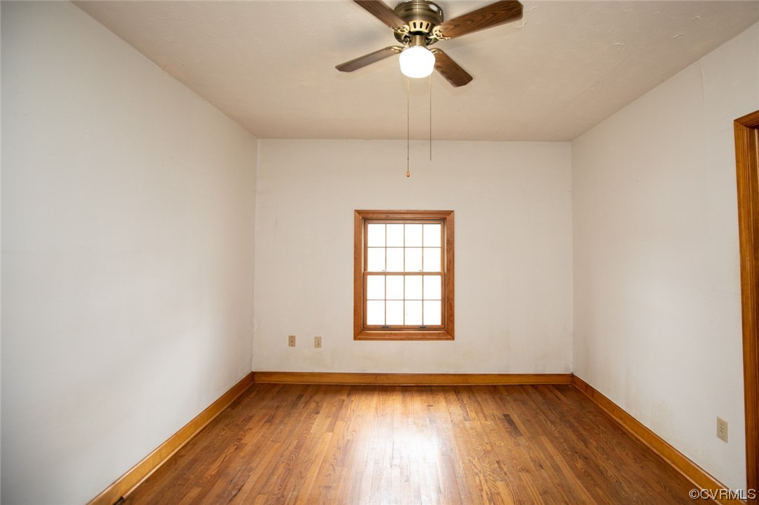 71 Spillman Road Farmville, VA 23901 - Photo 24 of 48 an empty room with wooden floor fan and windows