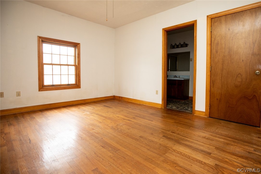 71 Spillman Road Farmville, VA 23901 - Photo 25 of 48 an empty room with wooden floor and windows