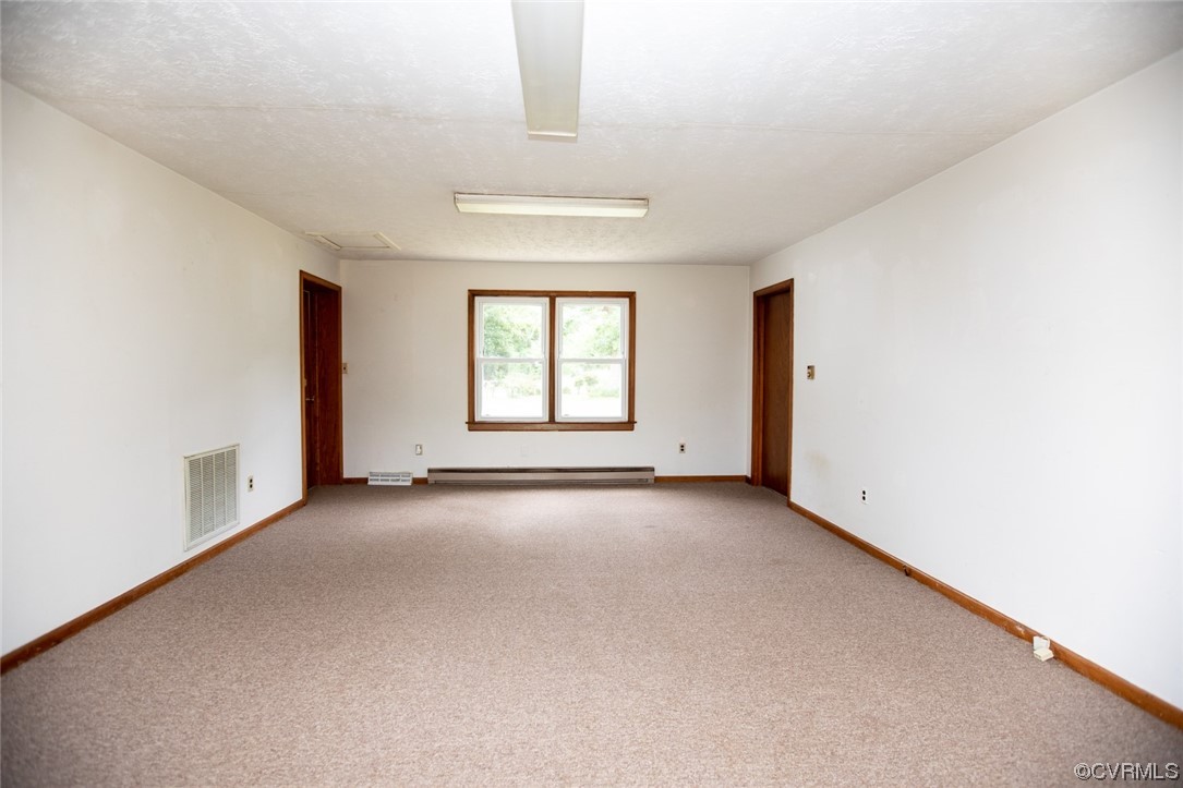 71 Spillman Road Farmville, VA 23901 - Photo 31 of 48 an empty room with a windows and a ceiling fan